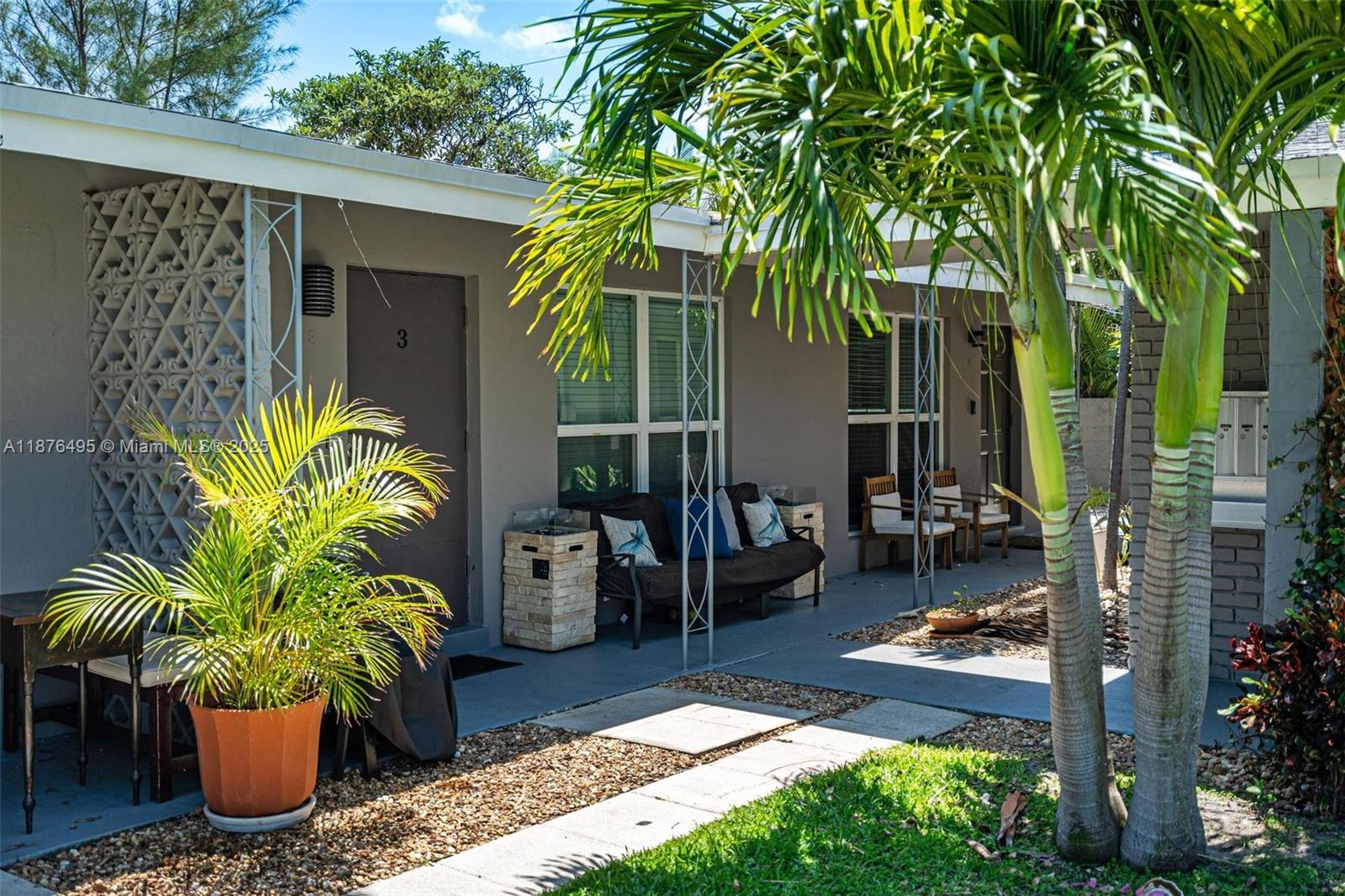 2201 Northeast 14th Avenue, Unit 9 Wilton Manors, FL 33305 - Photo 4 of 30 a view of a backyard with plants and patio
