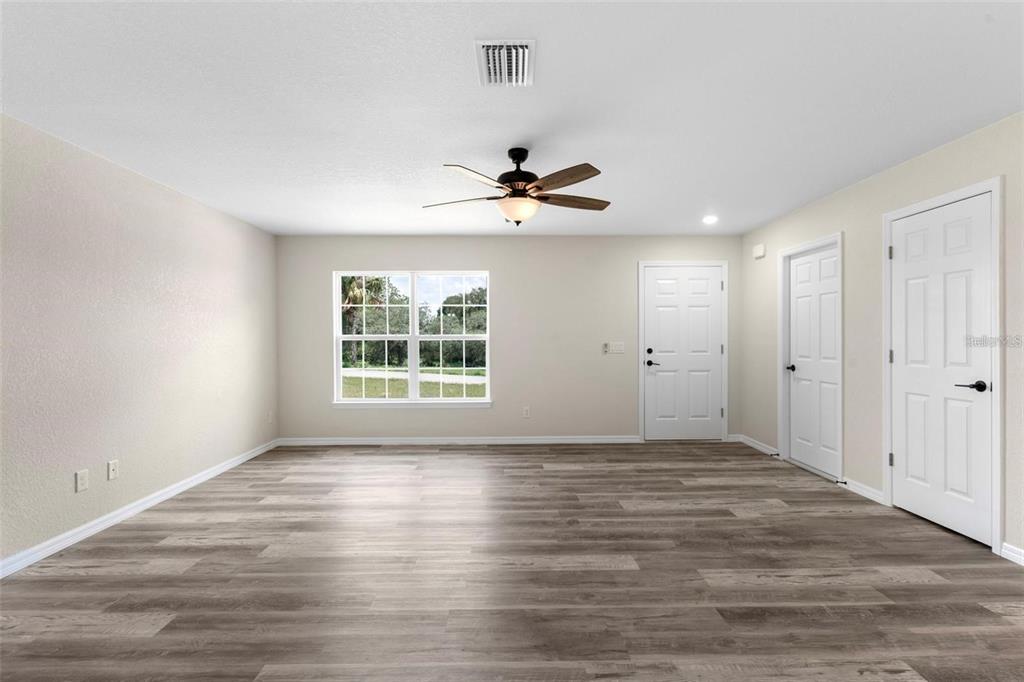 328 Eucalyptus Road Lake Wales, FL 33898 - Photo 11 of 18 a view of empty room with wooden floor and fan