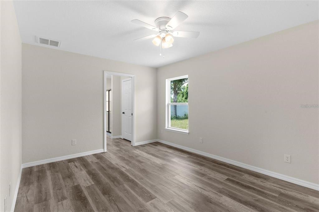 328 Eucalyptus Road Lake Wales, FL 33898 - Photo 12 of 18 wooden floor in an empty room with a window