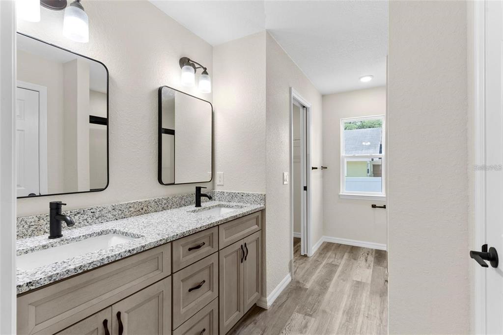 328 Eucalyptus Road Lake Wales, FL 33898 - Photo 14 of 18 a bathroom with double sink and a mirror