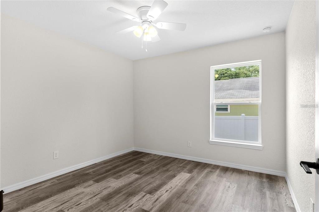 328 Eucalyptus Road Lake Wales, FL 33898 - Photo 15 of 18 an empty room with a window and a ceiling fan