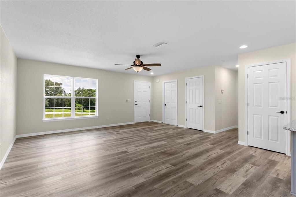 328 Eucalyptus Road Lake Wales, FL 33898 - Photo 4 of 18 a view of empty room with wooden floor and fan