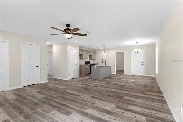 a view of a kitchen with furniture and a ceiling fan