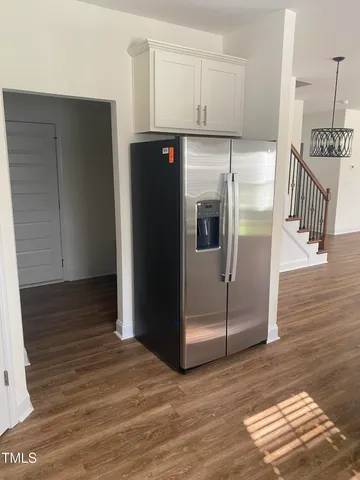 a kitchen with stainless steel appliances granite countertop a refrigerator and a stove