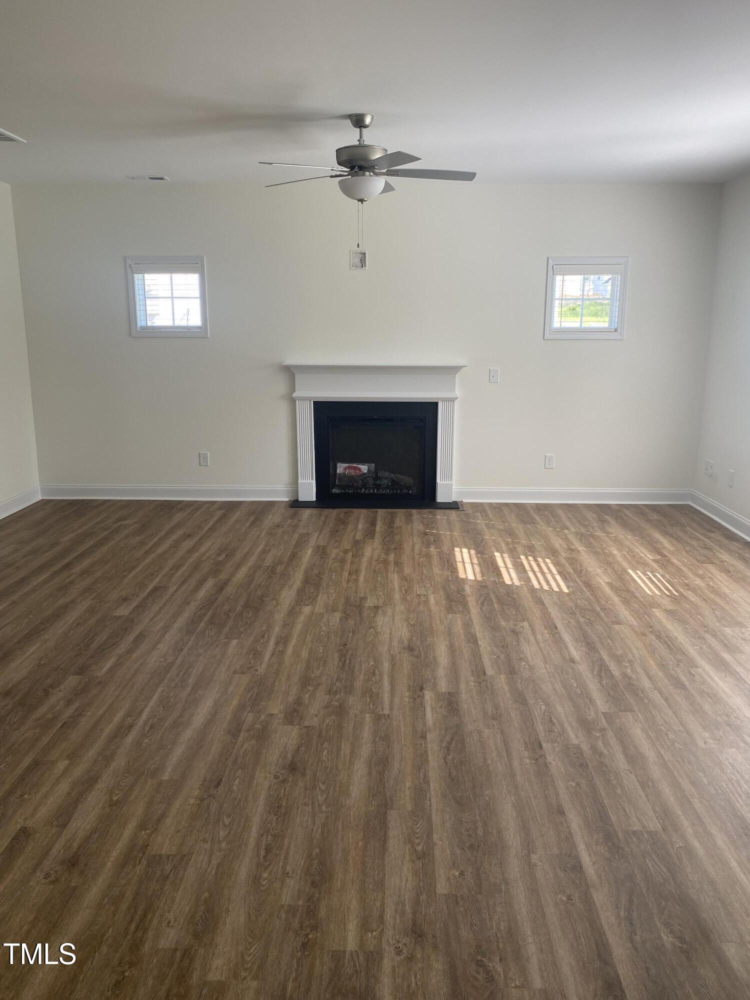 3862 Blackhills Road Fayetteville, NC 28311 - Photo 5 of 15 a view of an empty room with a fireplace and a window