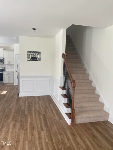 a view of entryway and hall with wooden floor