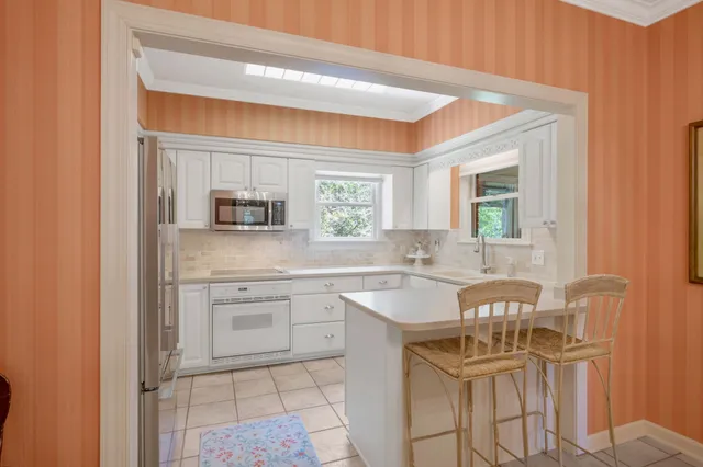 a kitchen with a sink cabinets and window