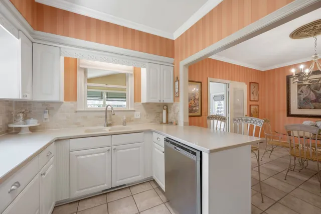 a kitchen with sink cabinets and wooden floor
