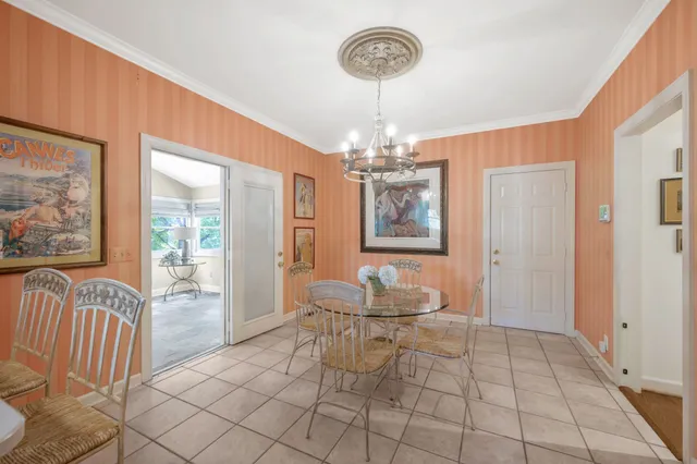 a view of a dining room with furniture and chandelier