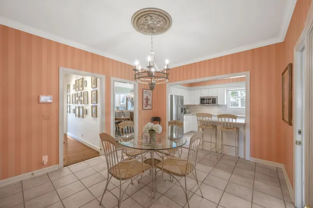 a view of a dining room with furniture and chandelier