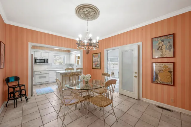 a view of a dining room with furniture and chandelier