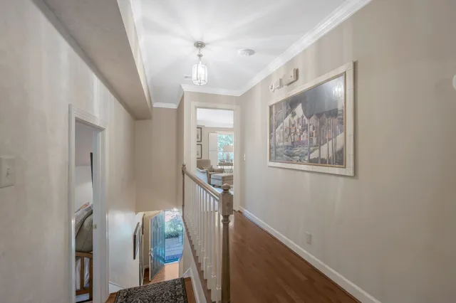 a view of a hallway with windows and stairs