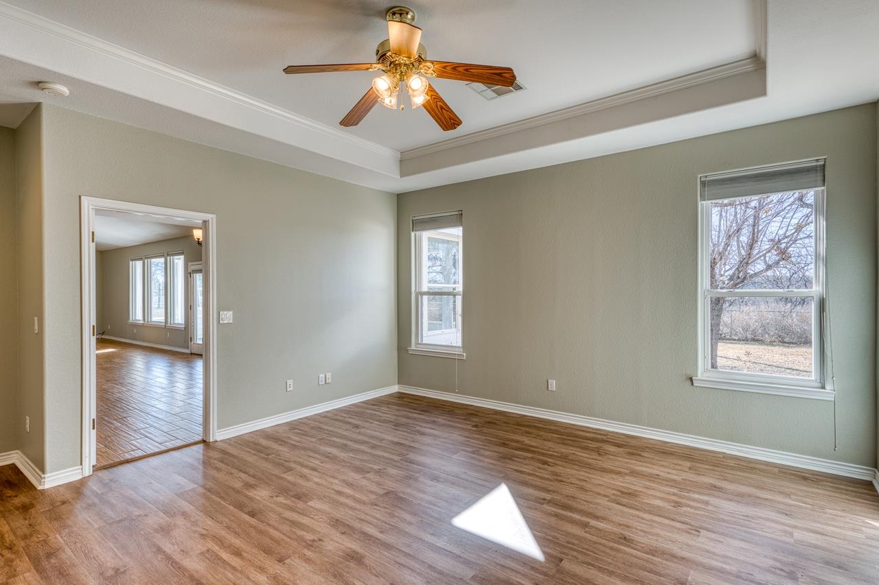2804 Oak Ridge Drive Horseshoe Bay, TX 78657 - Photo 12 of 30 a view of an empty room with window and wooden floor