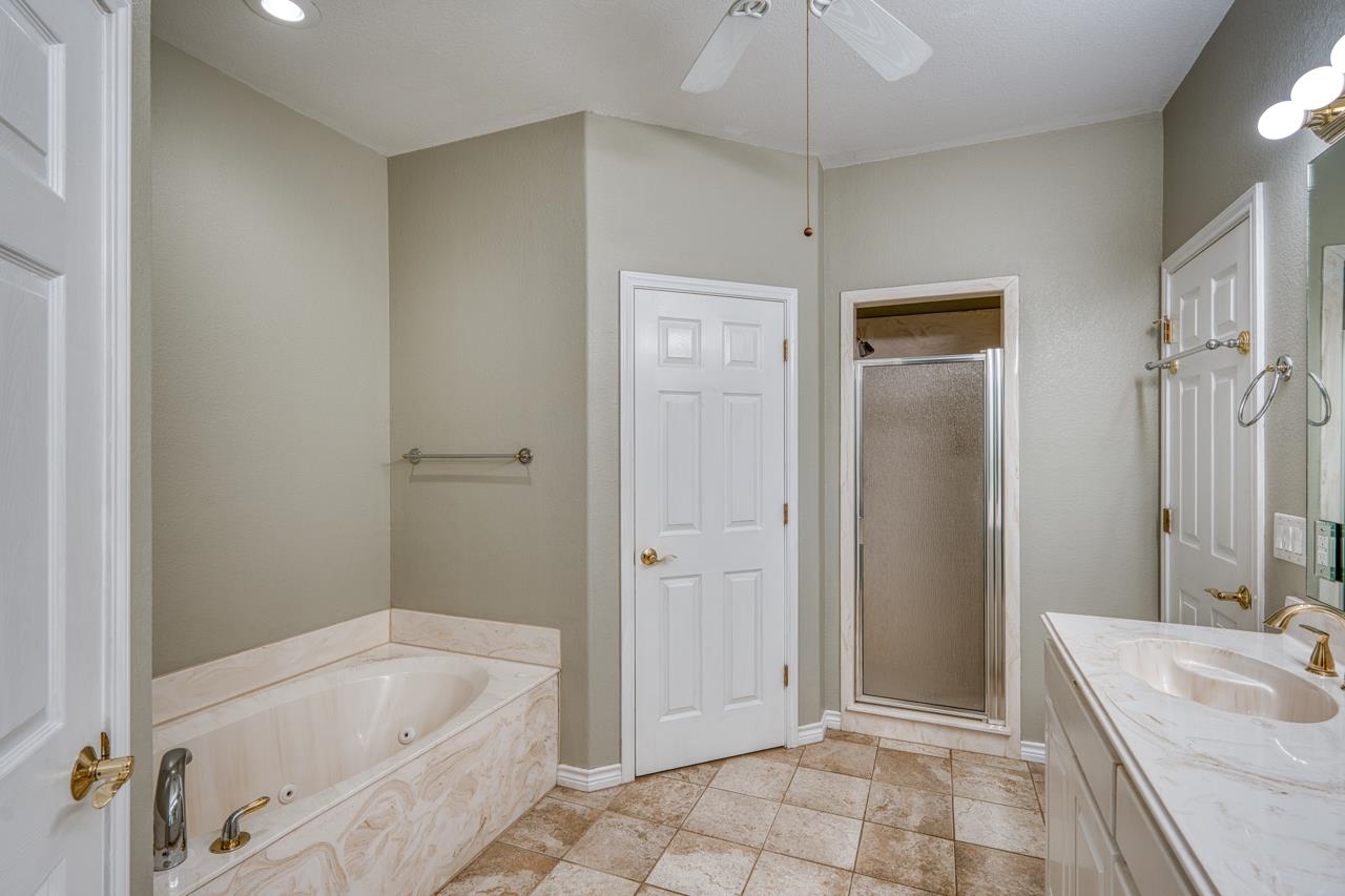 2804 Oak Ridge Drive Horseshoe Bay, TX 78657 - Photo 14 of 30 a bathroom with a tub a sink and a shower