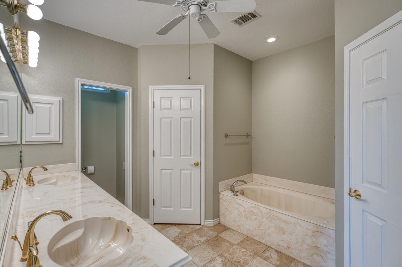 2804 Oak Ridge Drive Horseshoe Bay, TX 78657 - Photo 15 of 30 a spacious bathroom with a tub sink and mirror