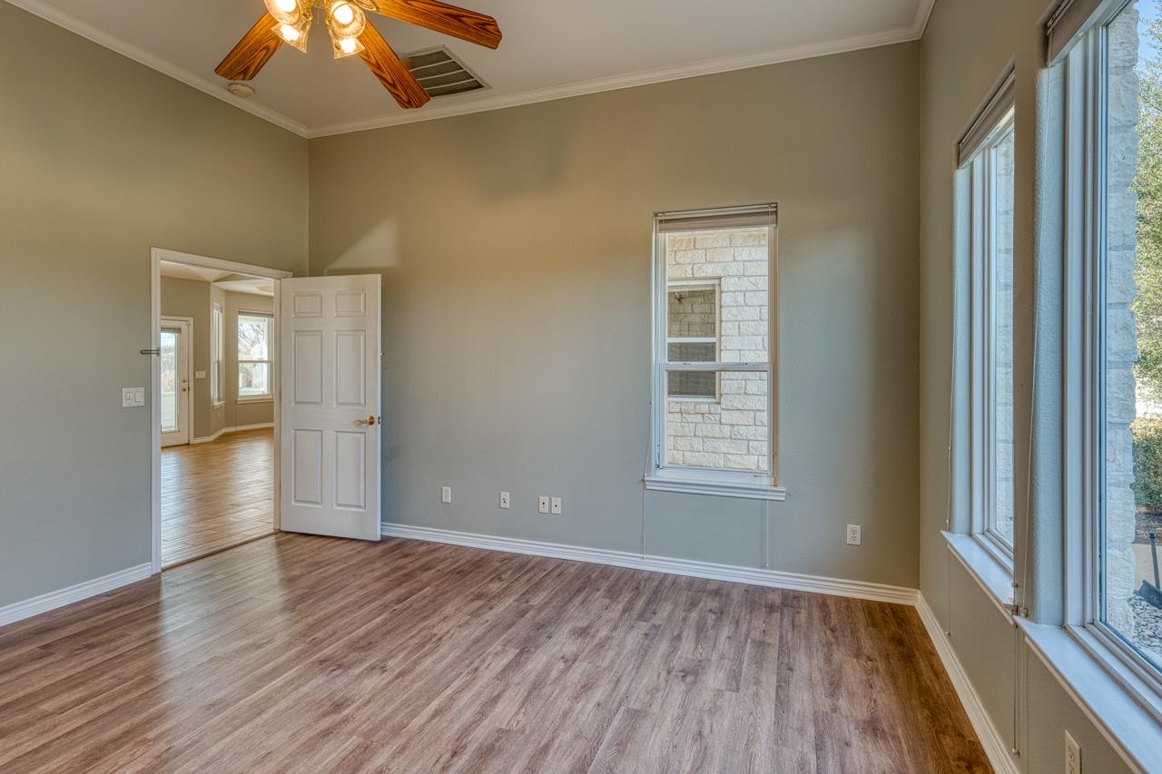 2804 Oak Ridge Drive Horseshoe Bay, TX 78657 - Photo 17 of 30 a view of an empty room with window and wooden floor