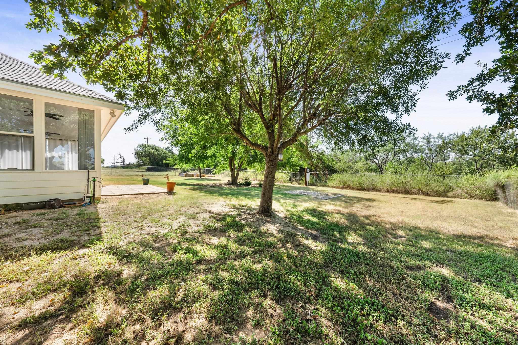 2804 Oak Ridge Drive Horseshoe Bay, TX 78657 - Photo 24 of 30 a view of a yard with plants and large trees