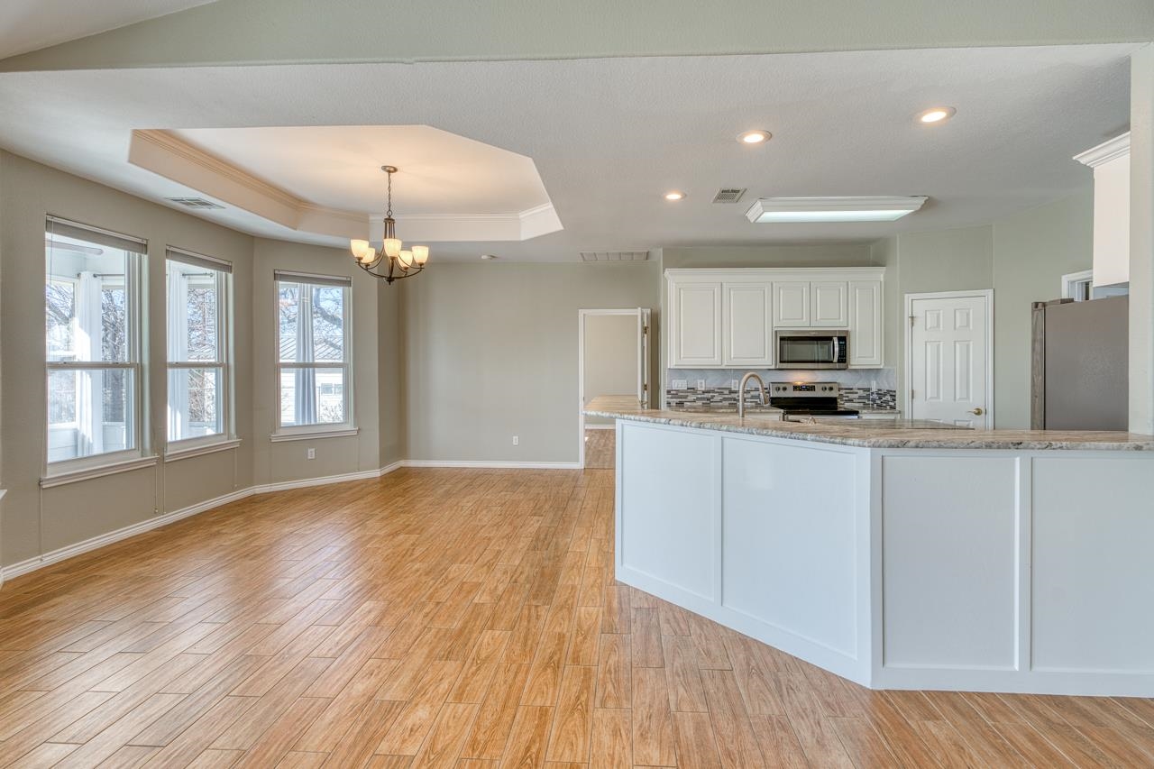 2804 Oak Ridge Drive Horseshoe Bay, TX 78657 - Photo 8 of 30 a kitchen with granite countertop a stove cabinets and wooden floor