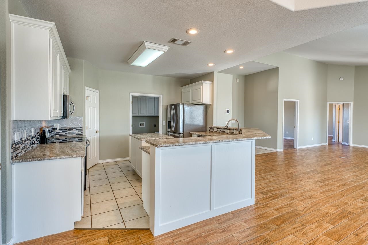 2804 Oak Ridge Drive Horseshoe Bay, TX 78657 - Photo 9 of 30 a kitchen with a sink cabinets and wooden floor