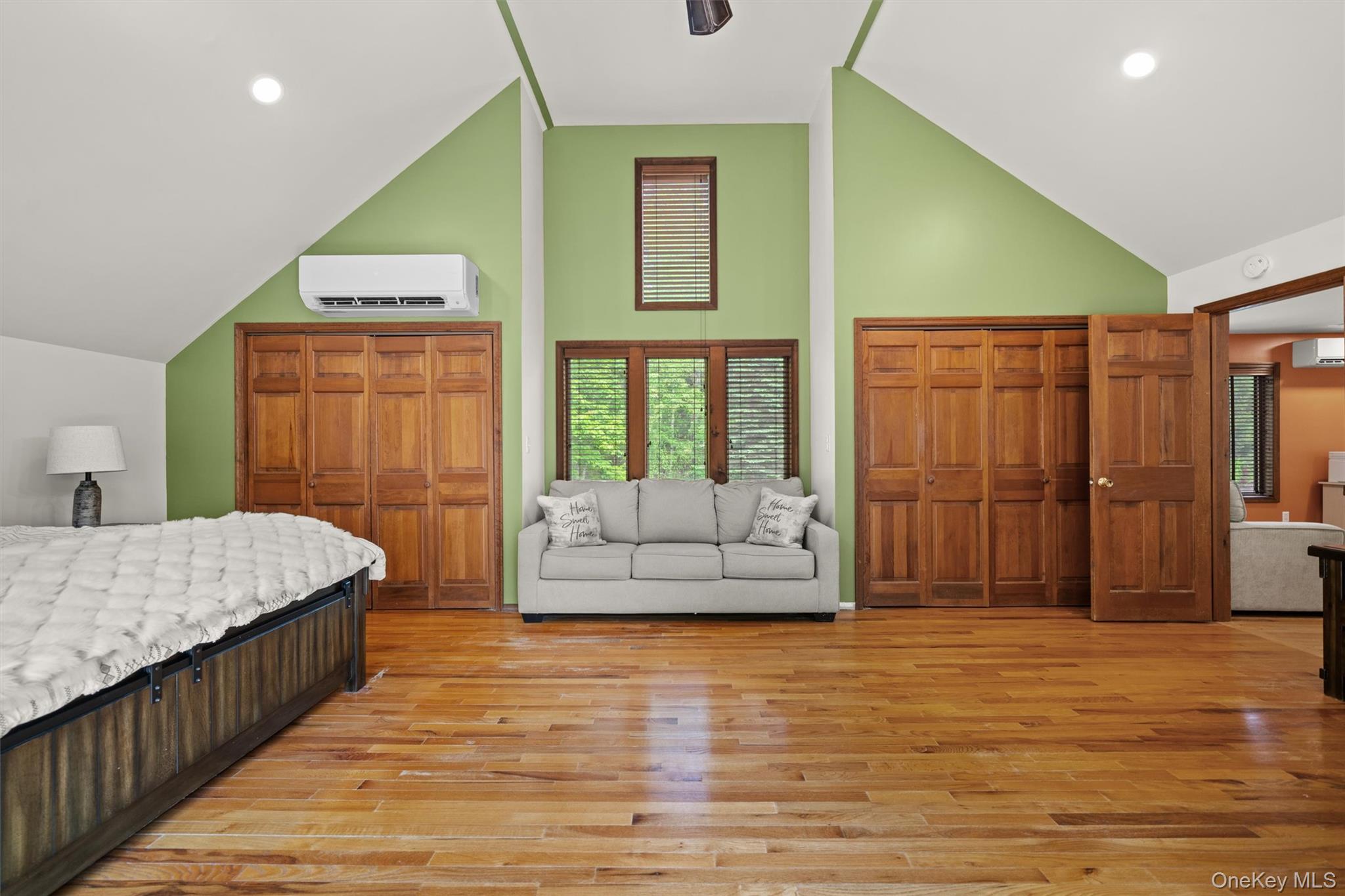 1775 Plank Rd Section A Forestburgh, NY 12777 - Photo 19 of 50 Bedroom with high vaulted ceiling, light wood-type flooring, an AC wall unit, and recessed lighting