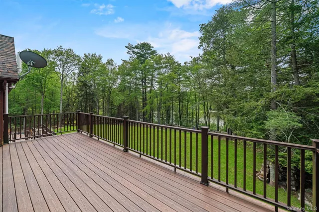 a view of balcony with wooden floor and fence