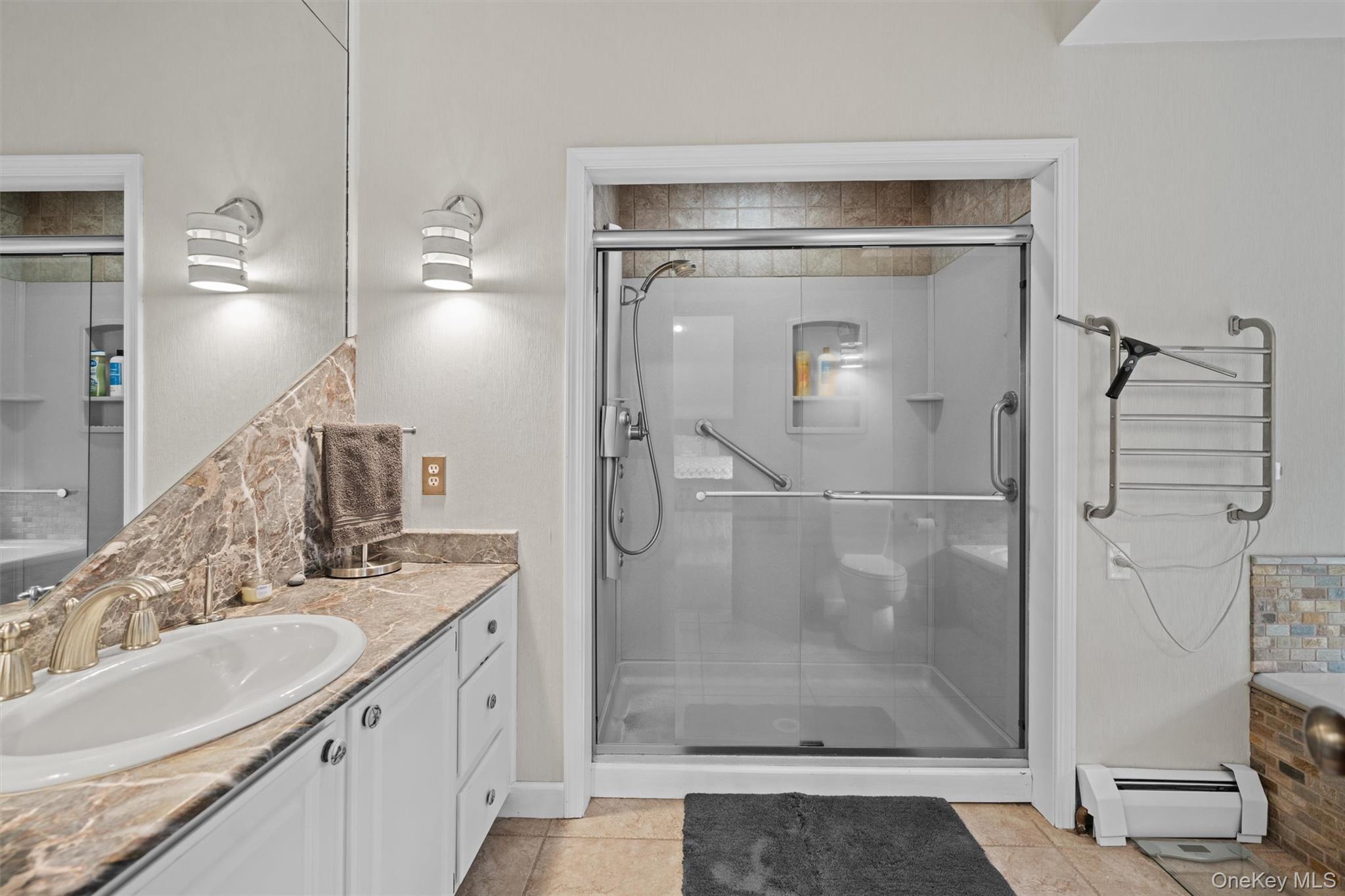 1775 Plank Rd Section A Forestburgh, NY 12777 - Photo 22 of 50 Full bath featuring a baseboard heating unit, vanity, a shower stall, and tile patterned flooring