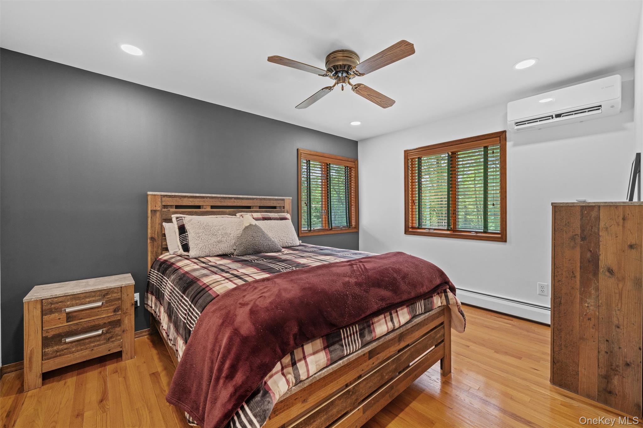 1775 Plank Rd Section A Forestburgh, NY 12777 - Photo 24 of 50 Bedroom with a wall mounted air conditioner, baseboard heating, wood finished floors, a ceiling fan, and recessed lighting