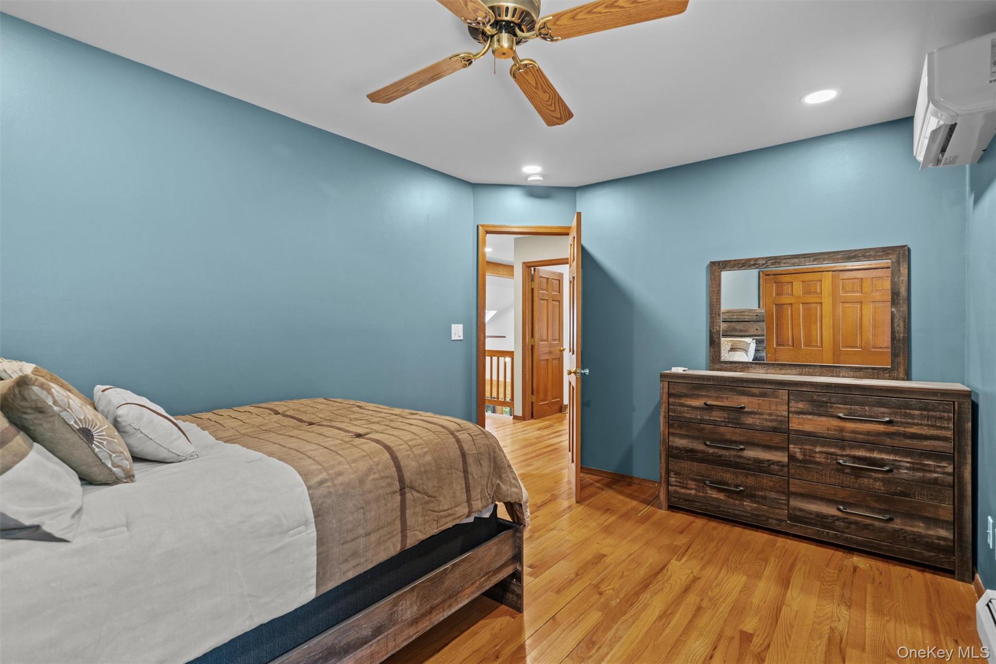 1775 Plank Rd Section A Forestburgh, NY 12777 - Photo 26 of 50 Bedroom featuring a wall unit AC, light wood-style floors, ceiling fan, a baseboard radiator, and recessed lighting