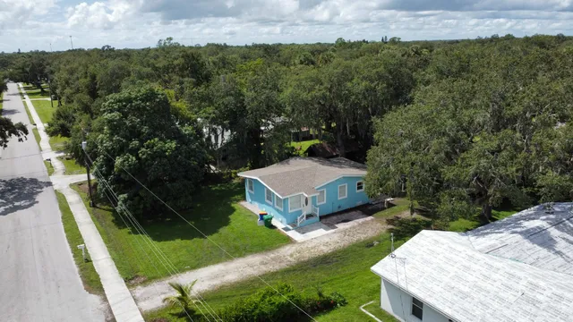 a view of a house with a yard and green space