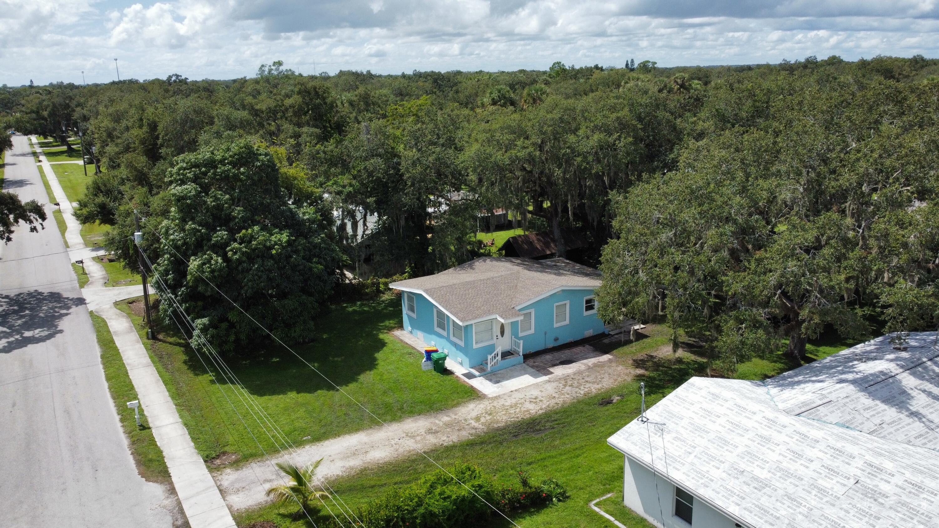 a view of a house with a yard and green space