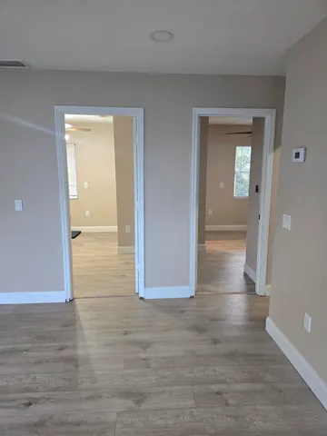 a view of a hallway with wooden floor