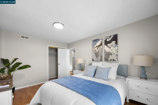 a bedroom with a bed and a potted plant