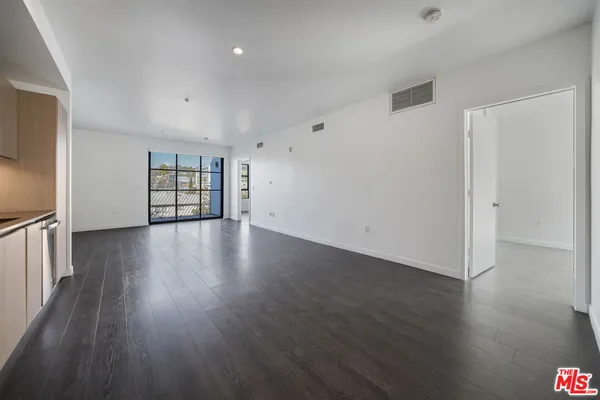 a view of a room with wooden floor and window