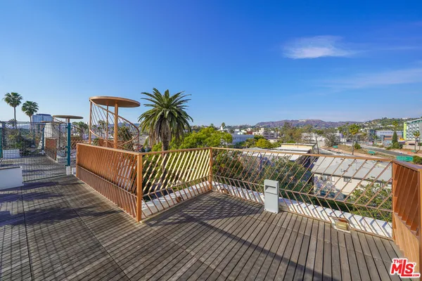 a view of a balcony with wooden floor
