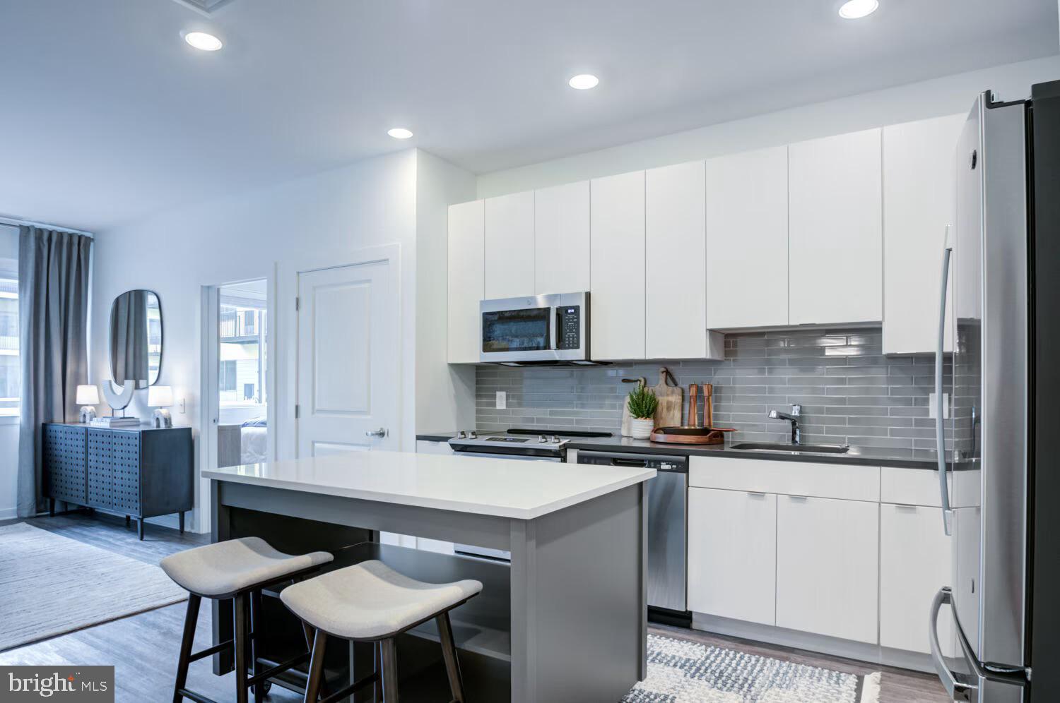 501-31 North Christopher Columbus Boulevard, Unit 1418 Philadelphia, PA 19123 - Photo 3 of 38 a kitchen with a sink stove and white cabinets