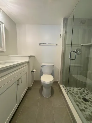 a bathroom with a toilet sink and shower
