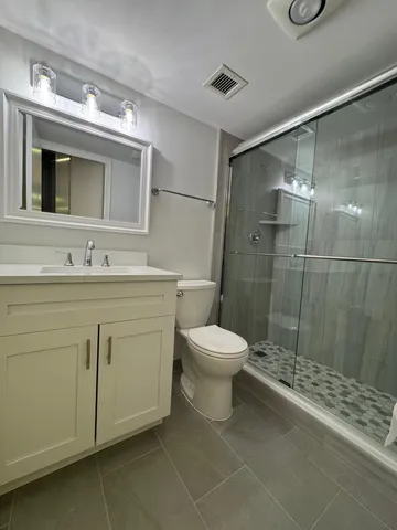 a bathroom with a toilet sink and a mirror
