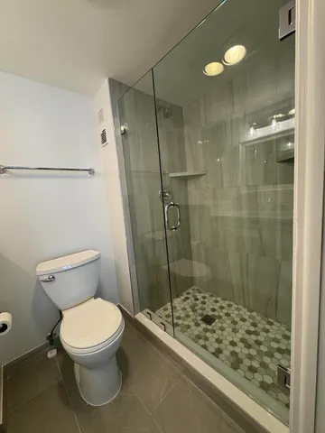 a bathroom with a toilet and shower