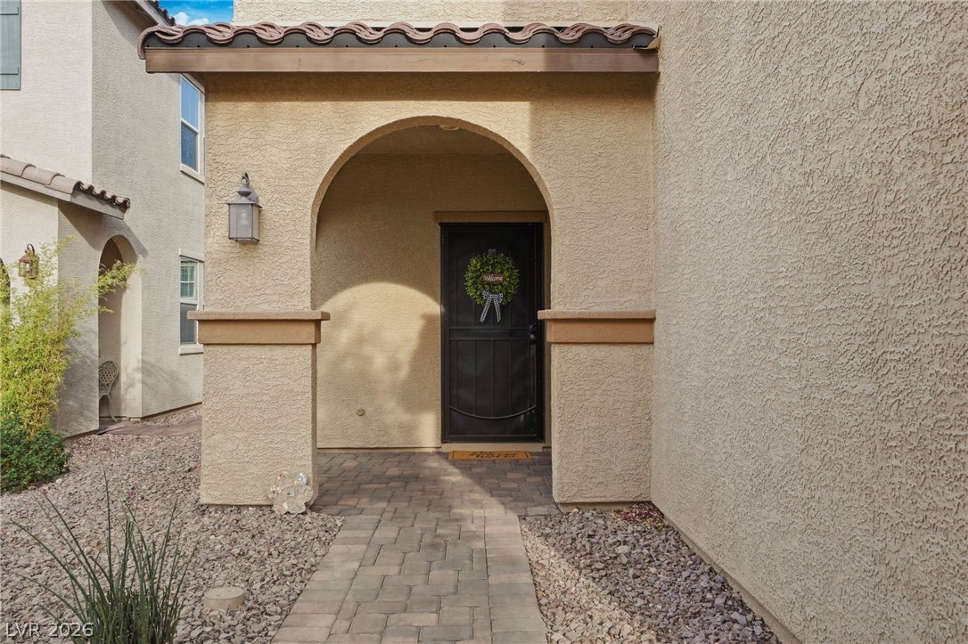 150 Fulgora Street Henderson, NV 89074 - Photo 9 of 92 Entrance to property with archway, stucco siding and a tile roof