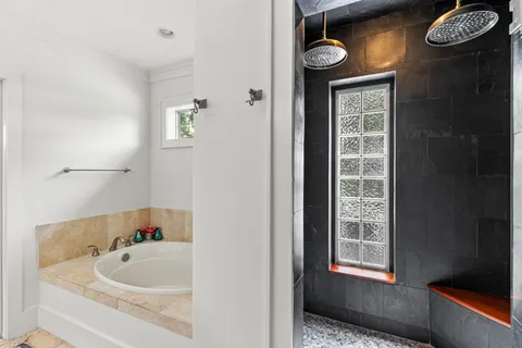 a bathroom with a bathtub and a shower