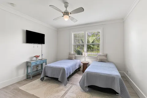 a bedroom with two beds and a flat screen tv