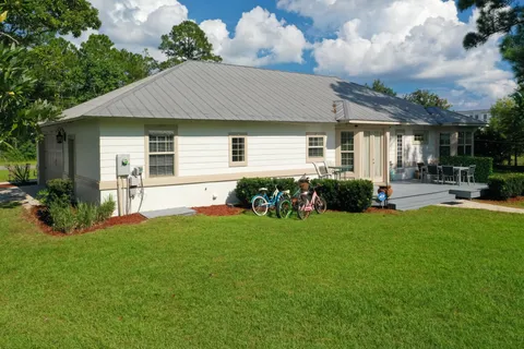a front view of house with yard and green space