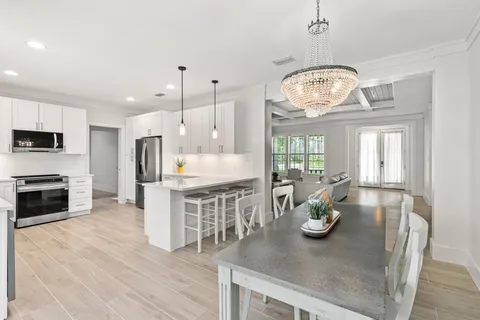 a kitchen with a table chairs and microwave