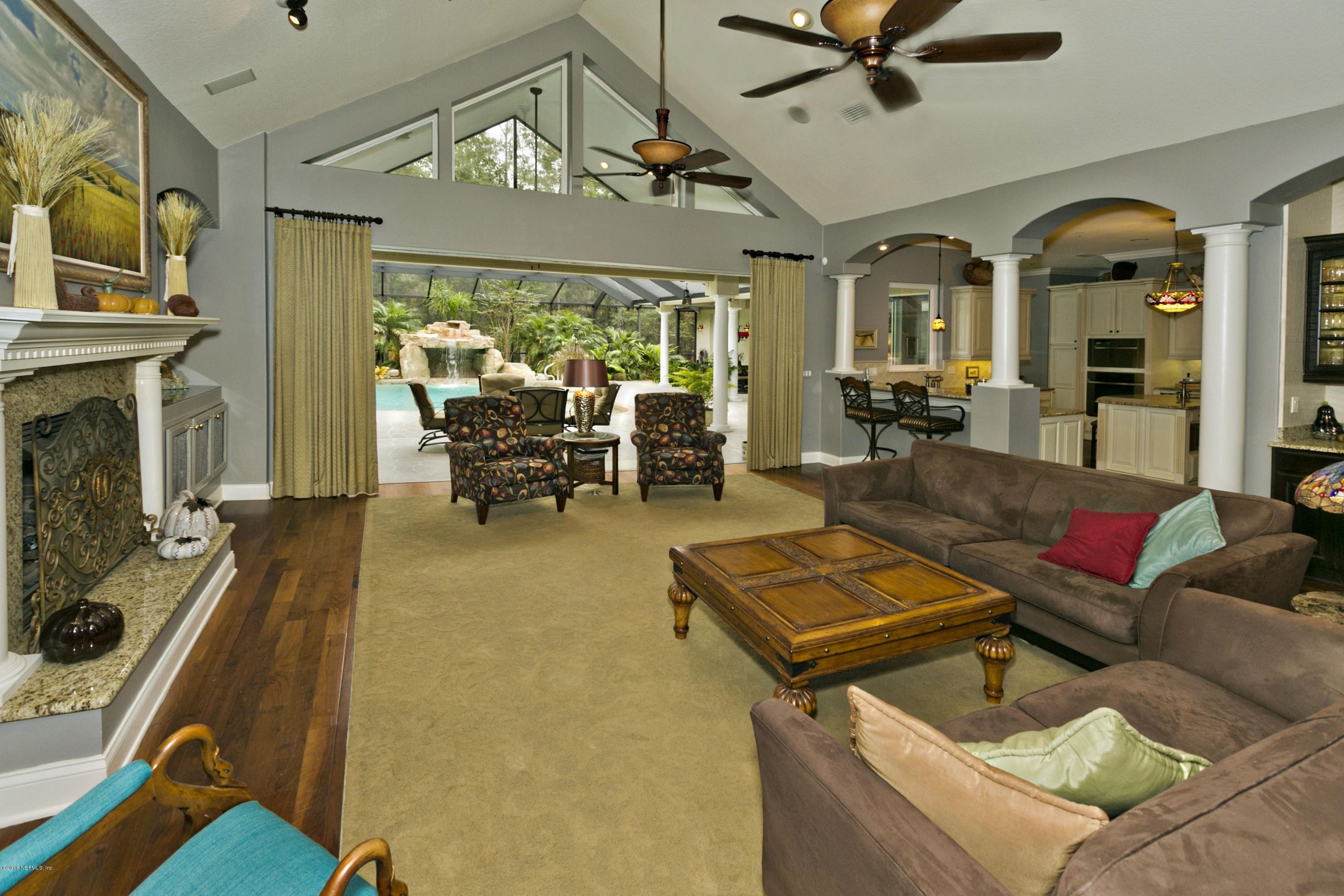 120 Dancing Horse Drive Hastings, FL 32145 - Photo 13 of 65 a living room with patio furniture and a fireplace