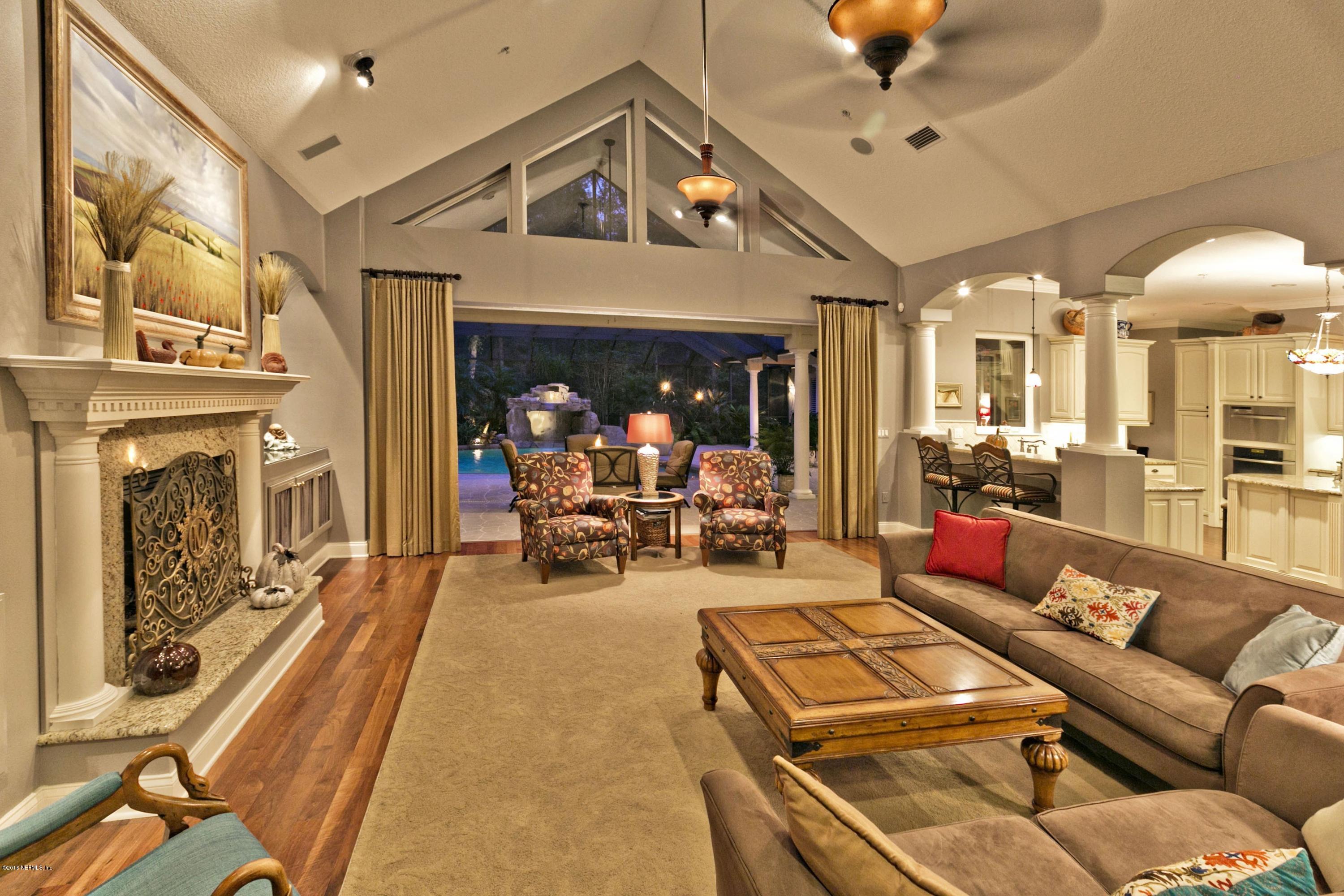 120 Dancing Horse Drive Hastings, FL 32145 - Photo 14 of 65 a living room with furniture a fireplace and a chandelier