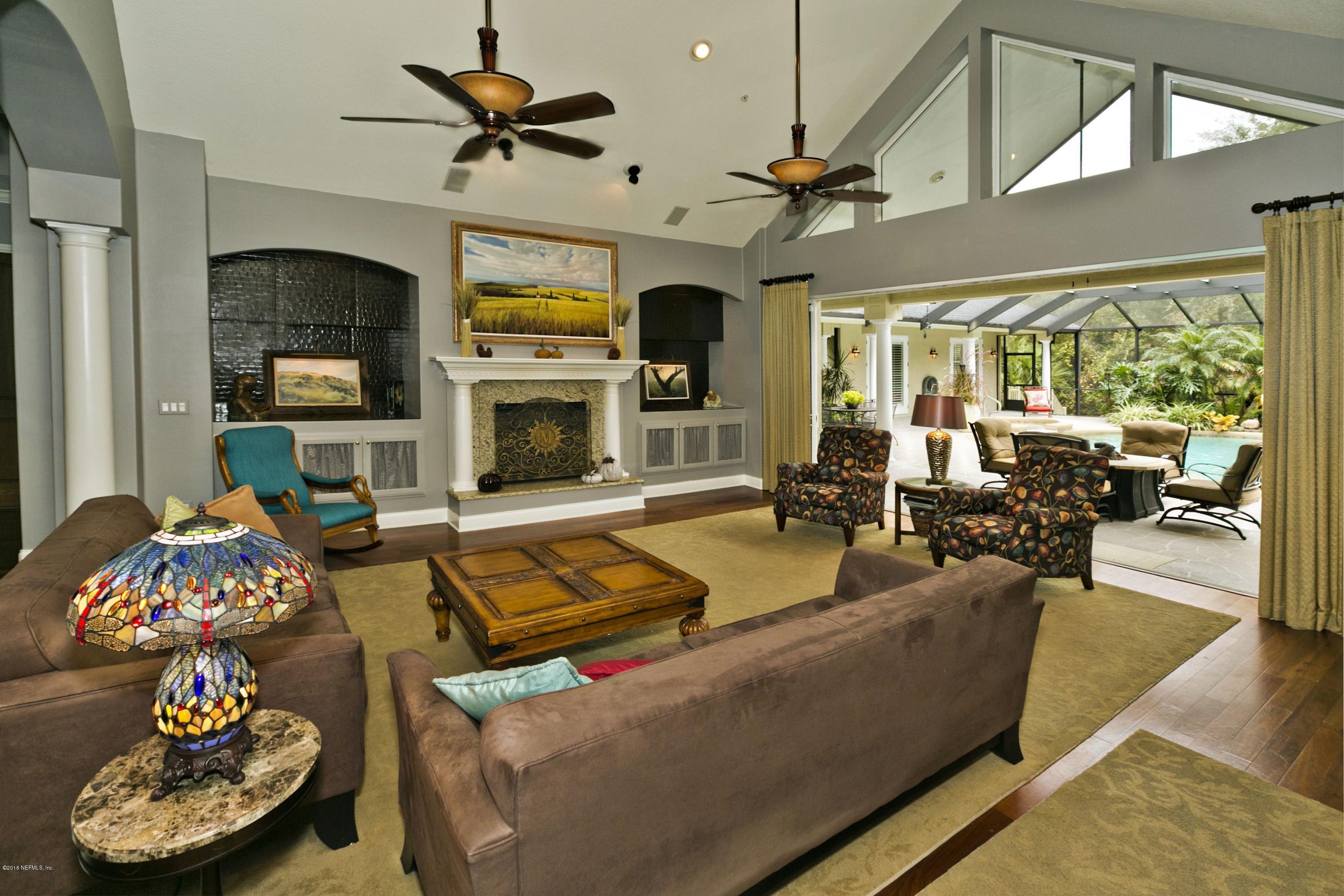120 Dancing Horse Drive Hastings, FL 32145 - Photo 15 of 65 a living room with furniture a fireplace and a flat screen tv