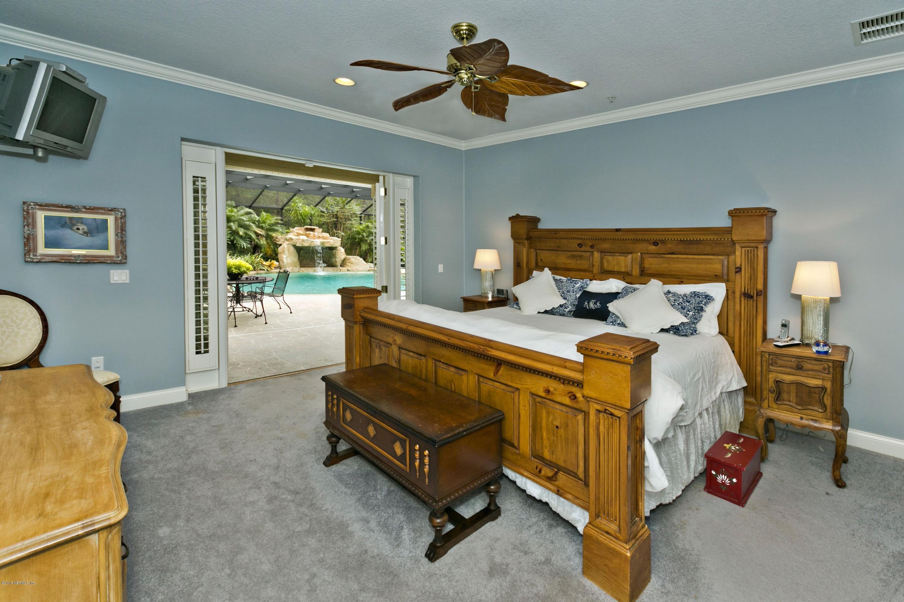 120 Dancing Horse Drive Hastings, FL 32145 - Photo 17 of 65 a bed room with a bed and a chandelier