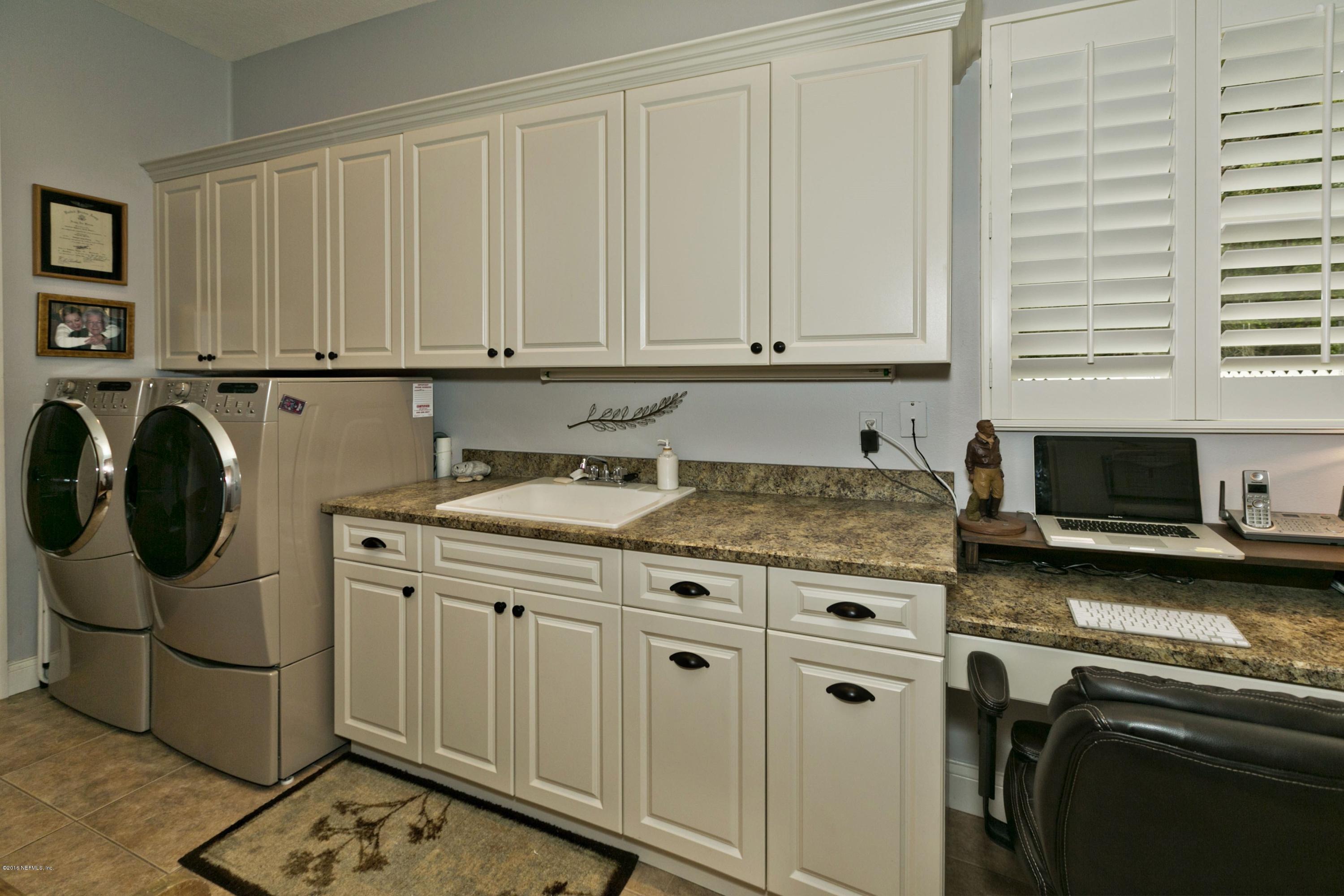 120 Dancing Horse Drive Hastings, FL 32145 - Photo 32 of 65 a kitchen with stainless steel appliances granite countertop a sink stove and cabinets