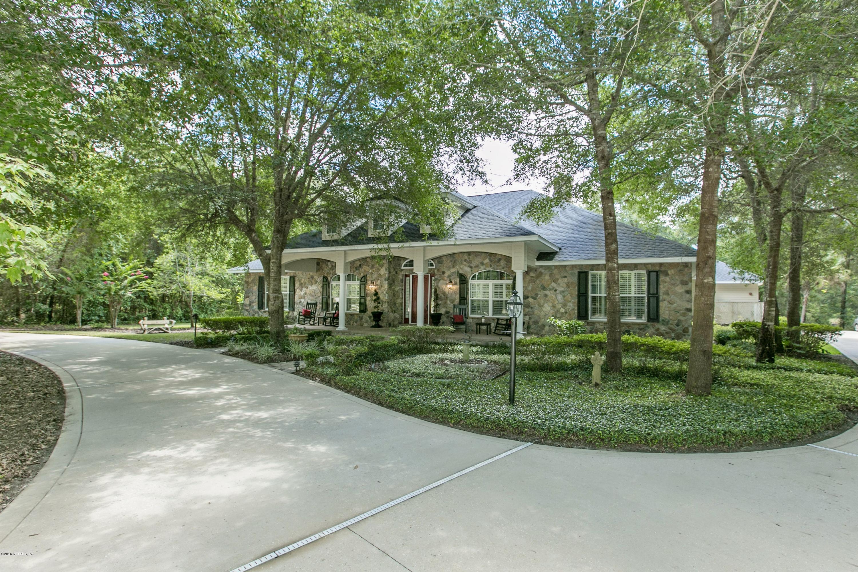 120 Dancing Horse Drive Hastings, FL 32145 - Photo 49 of 65 a front view of a house with a garden