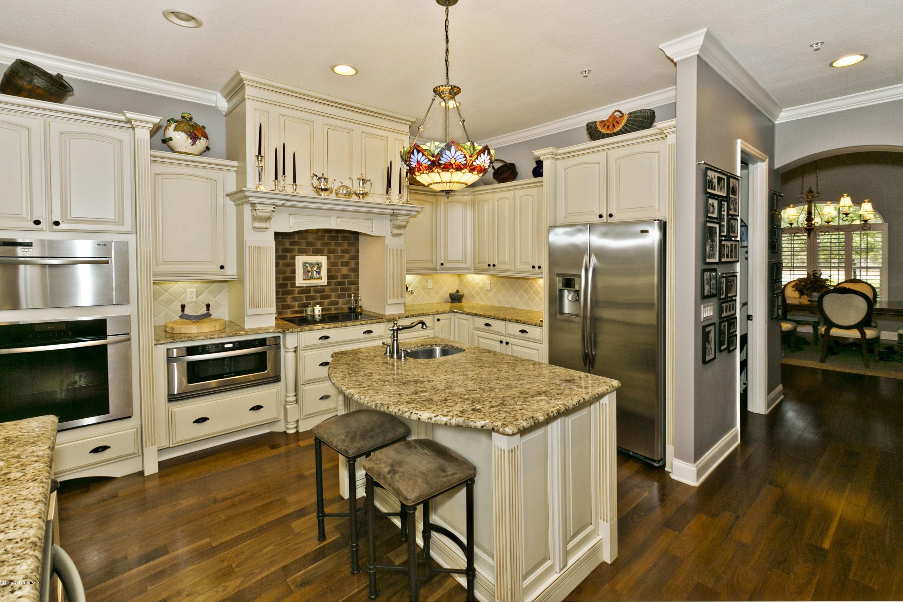 120 Dancing Horse Drive Hastings, FL 32145 - Photo 8 of 65 a kitchen with refrigerator a stove and wooden floor